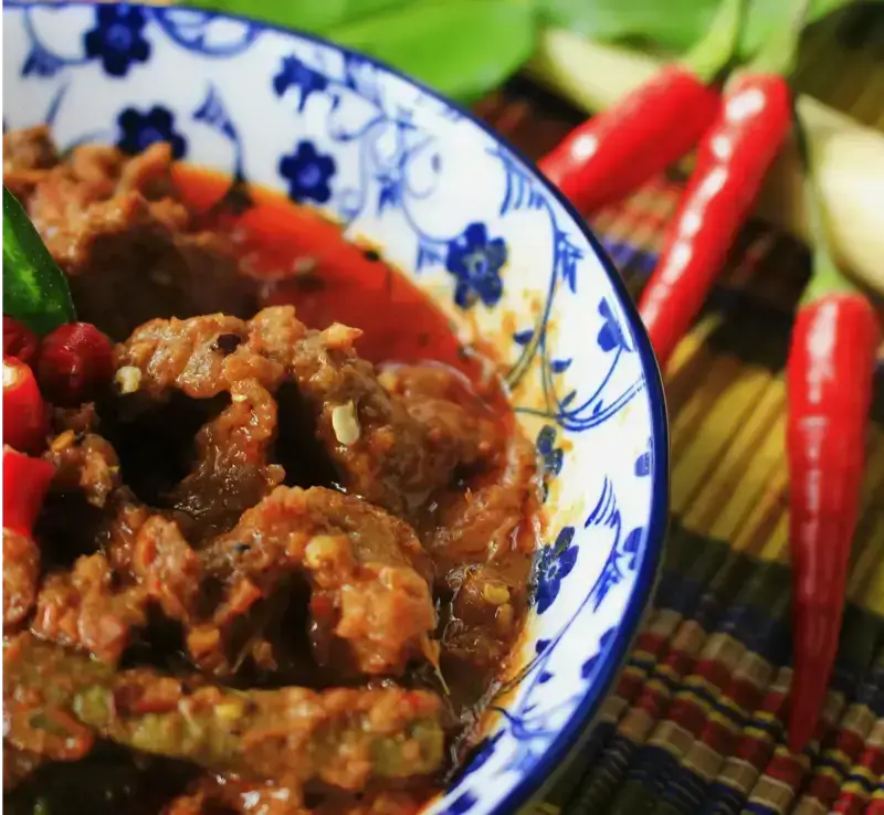 Rendang, a rich and tender coconut beef stew, highlighting our authentic cuisine options