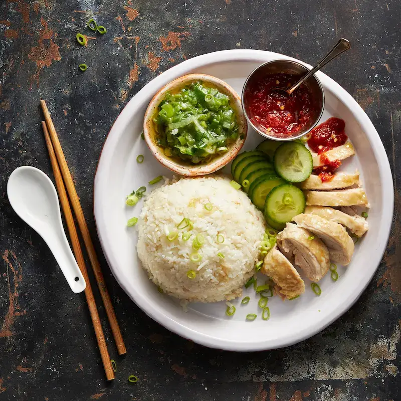 Poached chicken with seasoned rice and dipping sauces