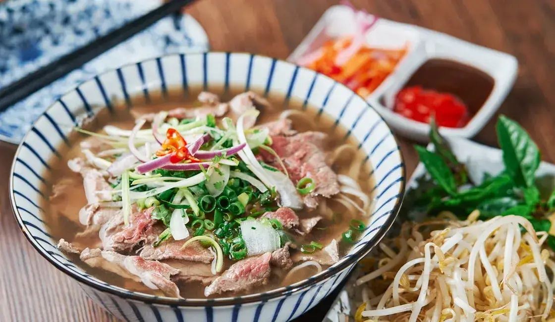 Vietnamese noodle soup with beef, herbs, and lime