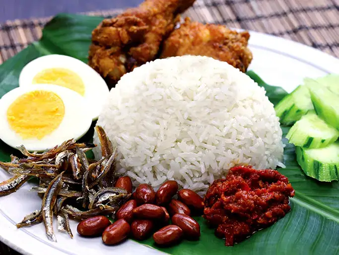 Rice served with sambal, anchovies, peanuts, and boiled egg